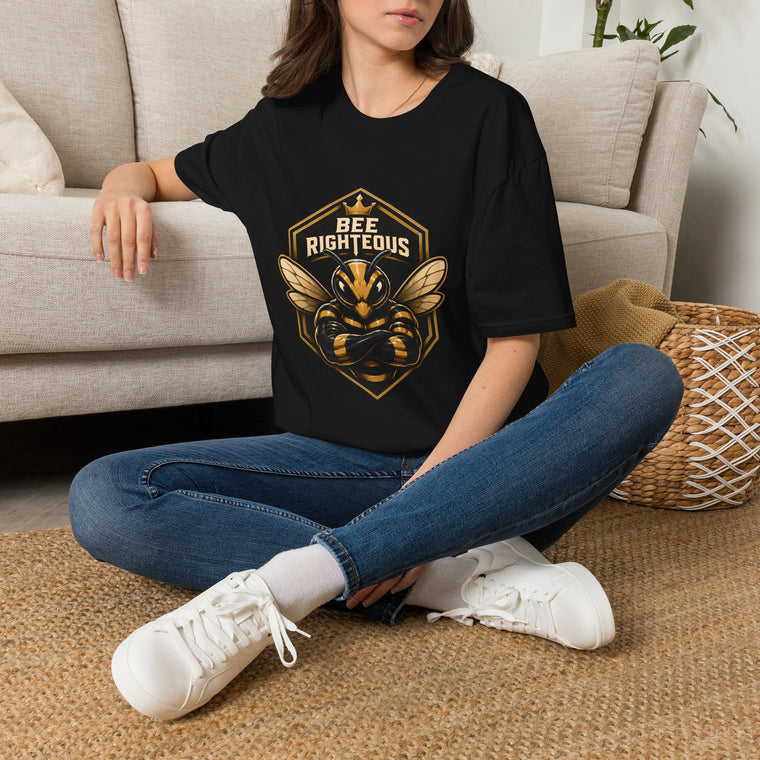 Person wearing a black t-shirt with 'Backyard Bottling Co' logo sitting on the floor.