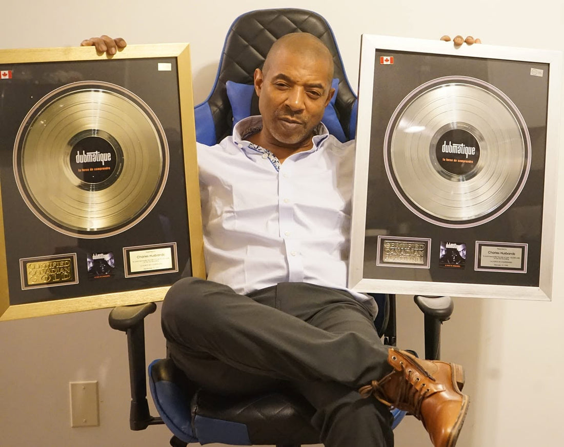 Chuck Ice seated with Canadian gold and platinum music recognition plaques