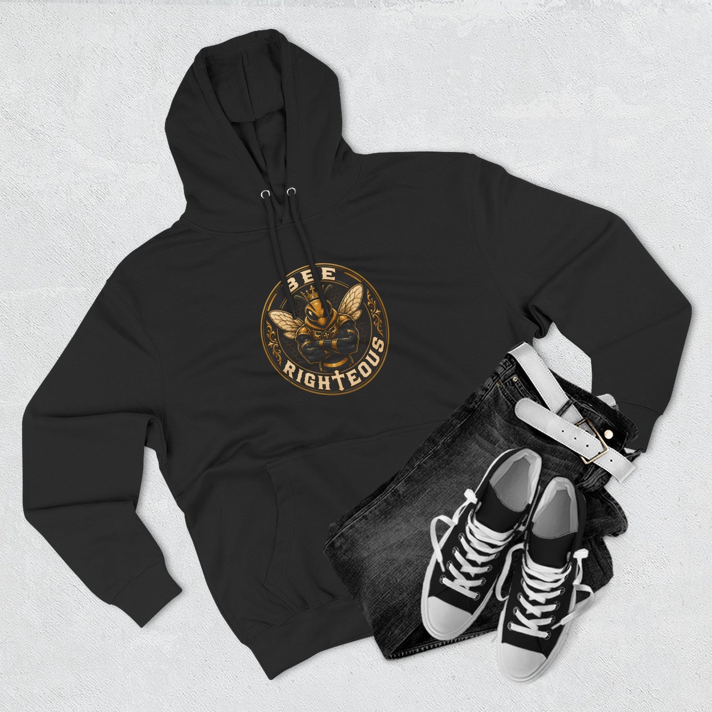 Black hoodie with a tree-of-life design, black jeans, and black sneakers on a light gray background