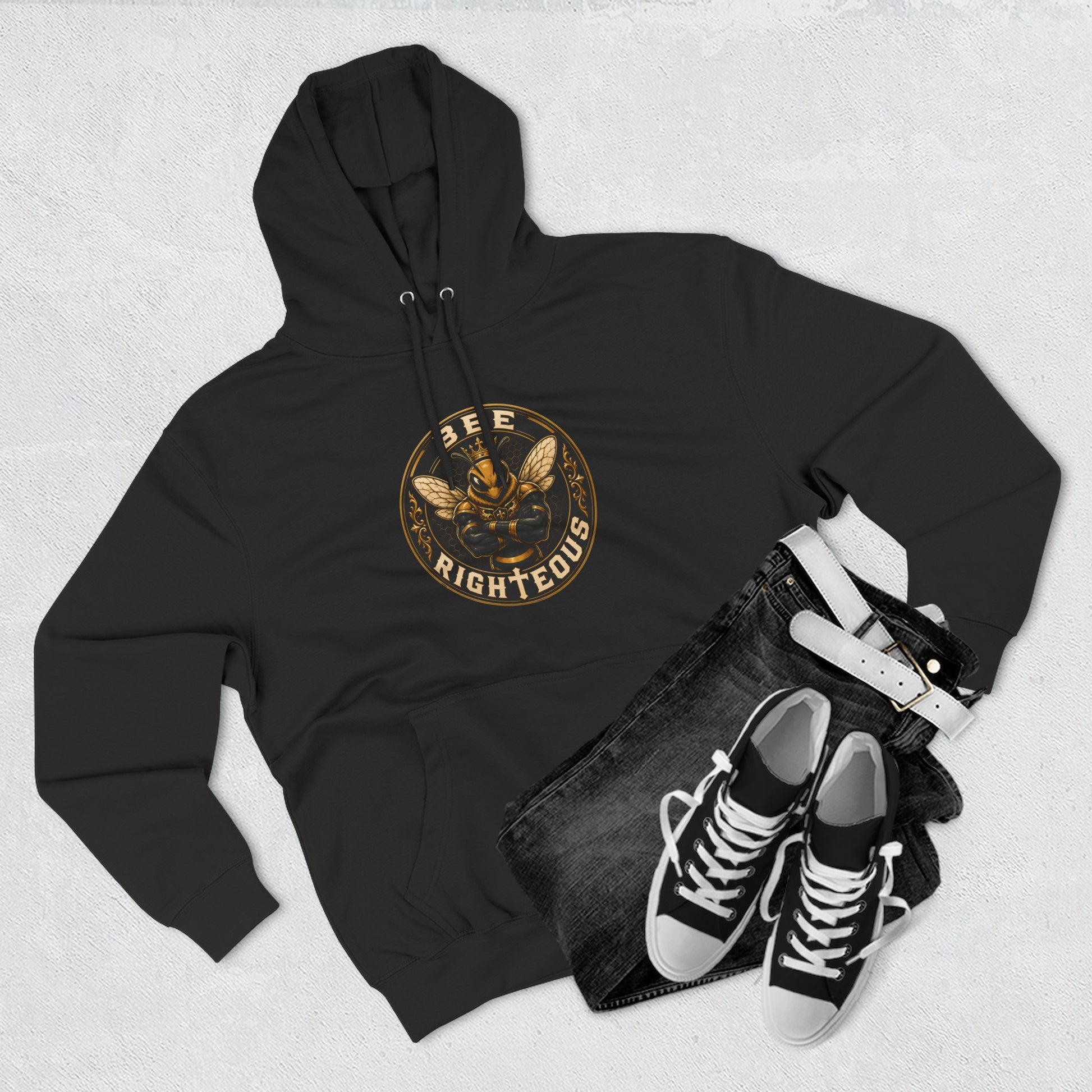 Black hoodie with a tree-of-life design, black jeans, and black sneakers on a light gray background
