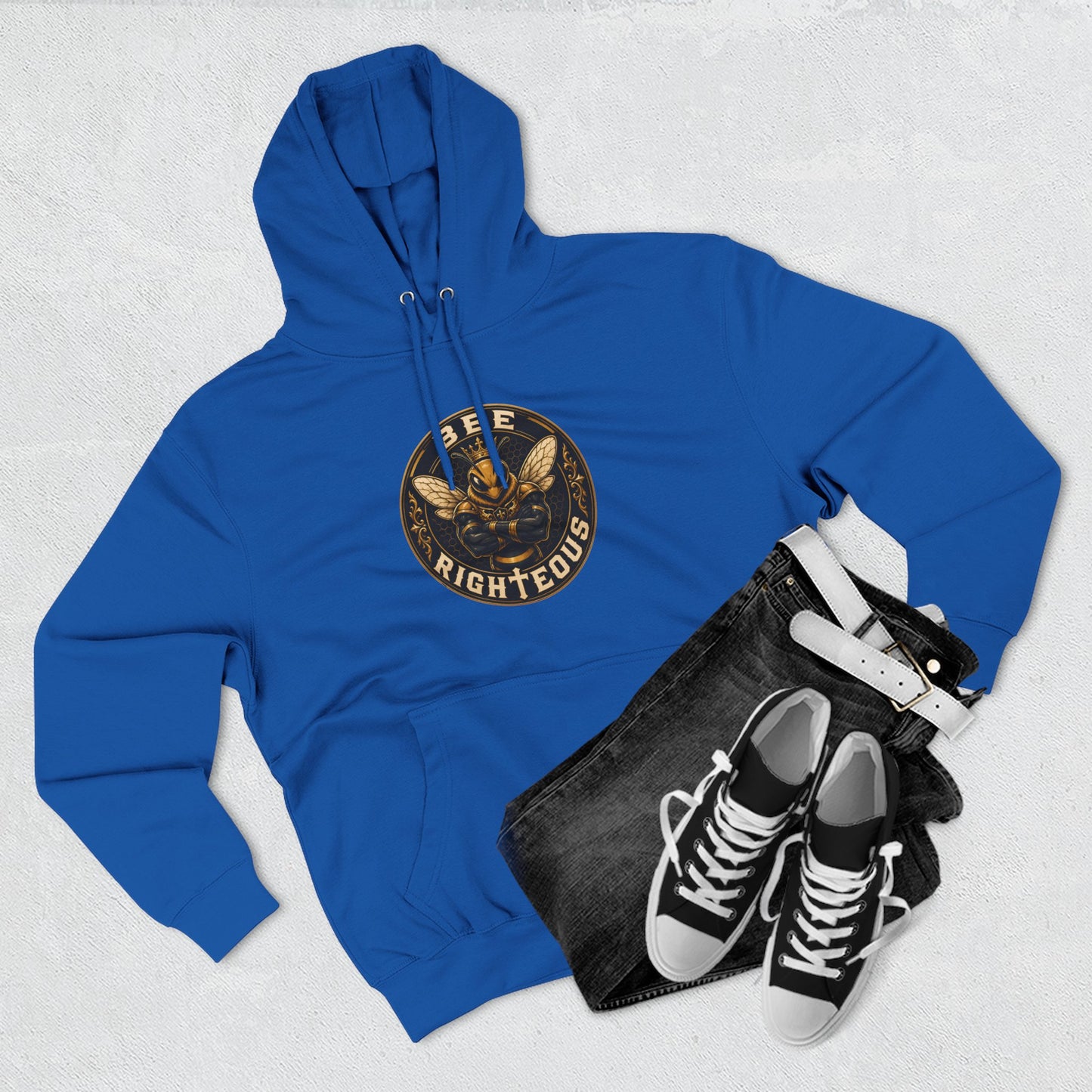 Blue hoodie with a family reunion design, black bag, and black sneakers on a light gray background