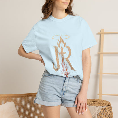 Person wearing a light blue t-shirt with a design and denim shorts on a neutral background