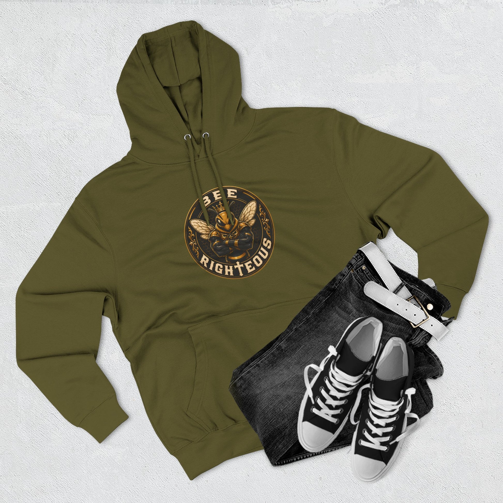 Green hoodie with text, black jeans, and black sneakers on a light gray background