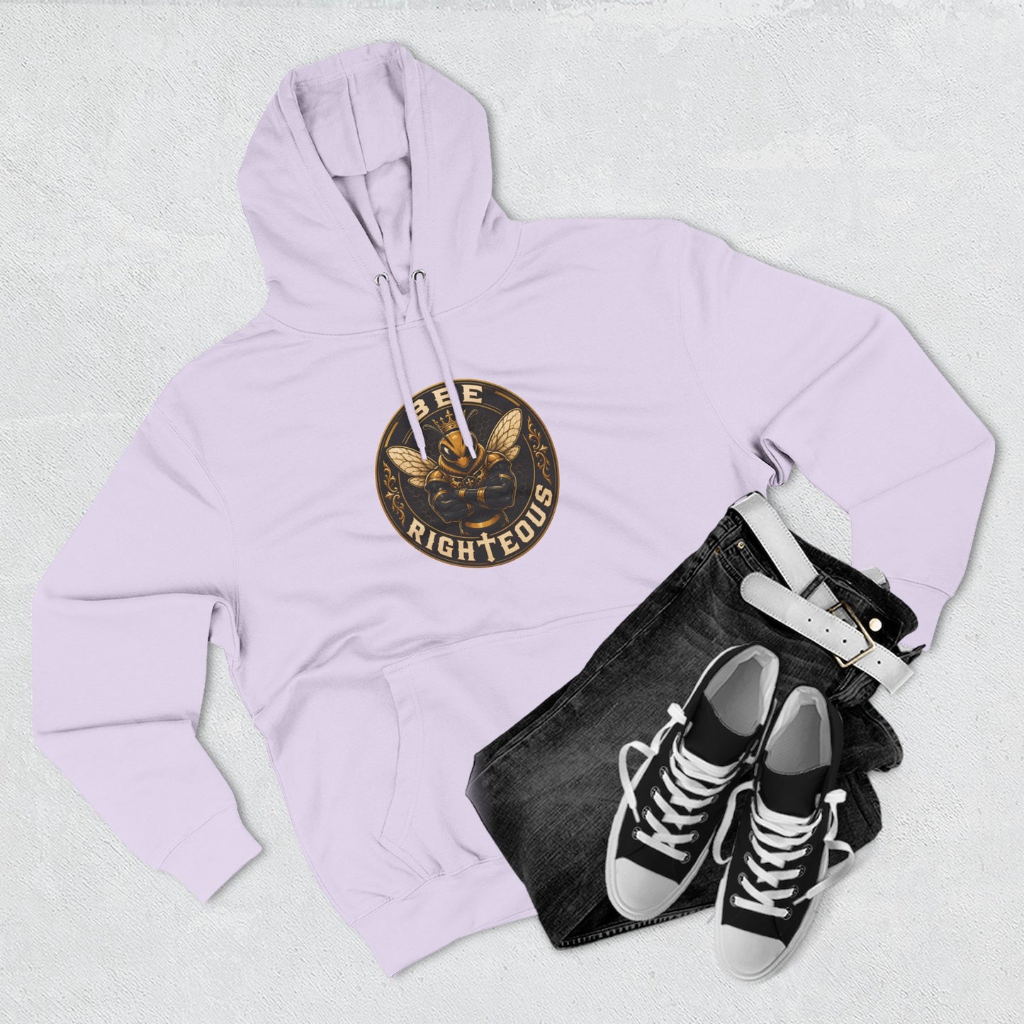 Lavender hoodie with a logo, black jeans, and black sneakers on a light gray background