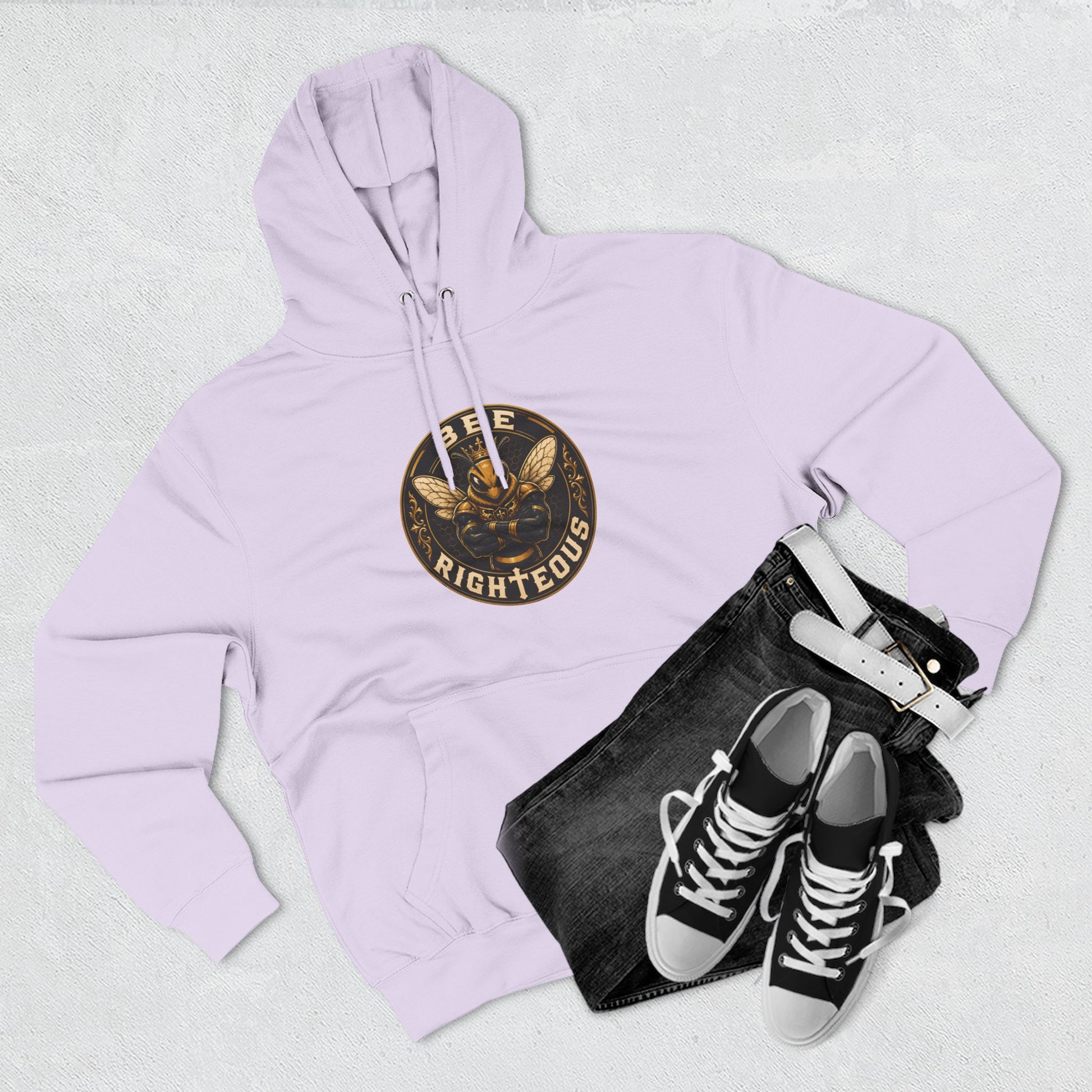 Lavender hoodie with a logo, black jeans, and black sneakers on a light gray background