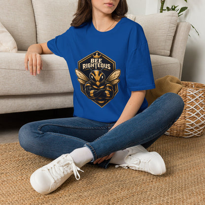 Person wearing a blue t-shirt with a graphic design sitting on the floor in a living room.
