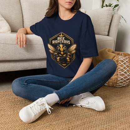 Person wearing a navy blue t-shirt with a graphic design and text, sitting on the floor in a living room.