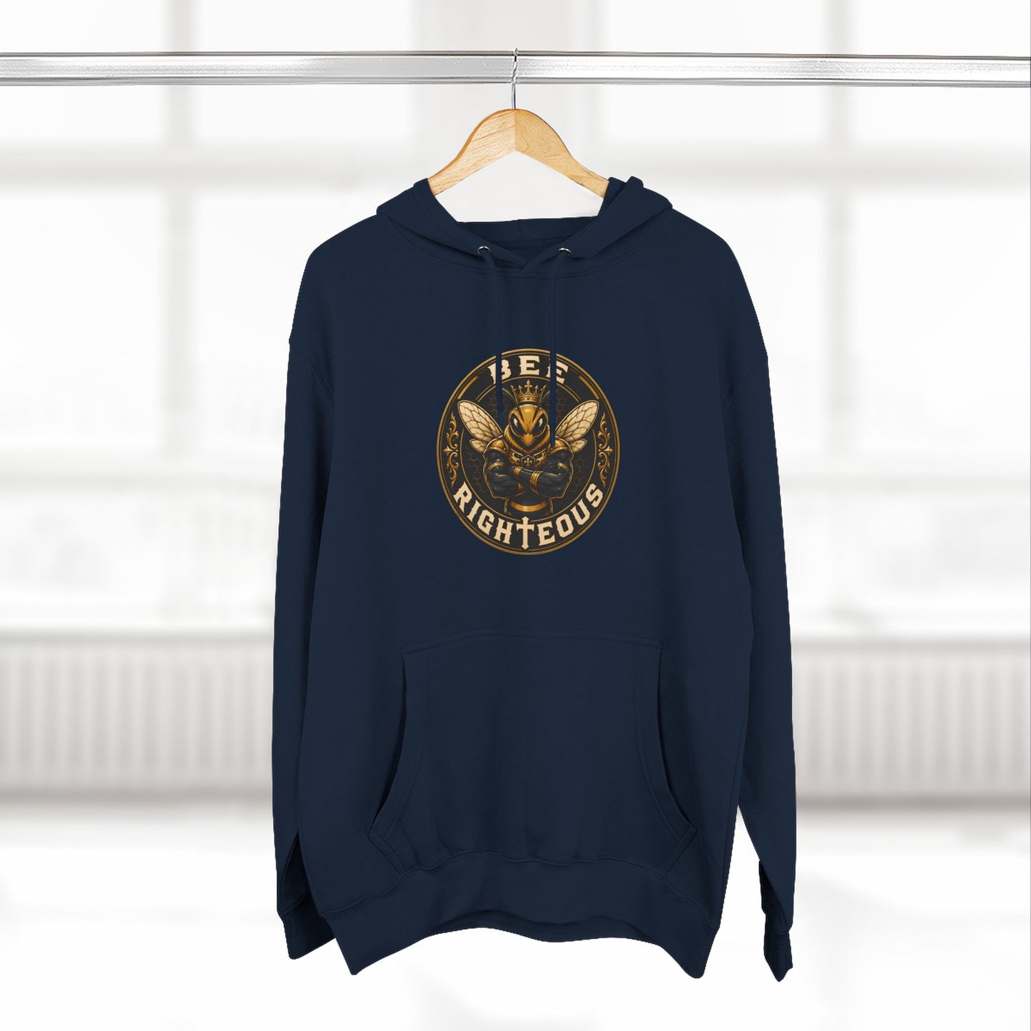 Green hoodie with a gold and white graphic design on a hanger against a white background