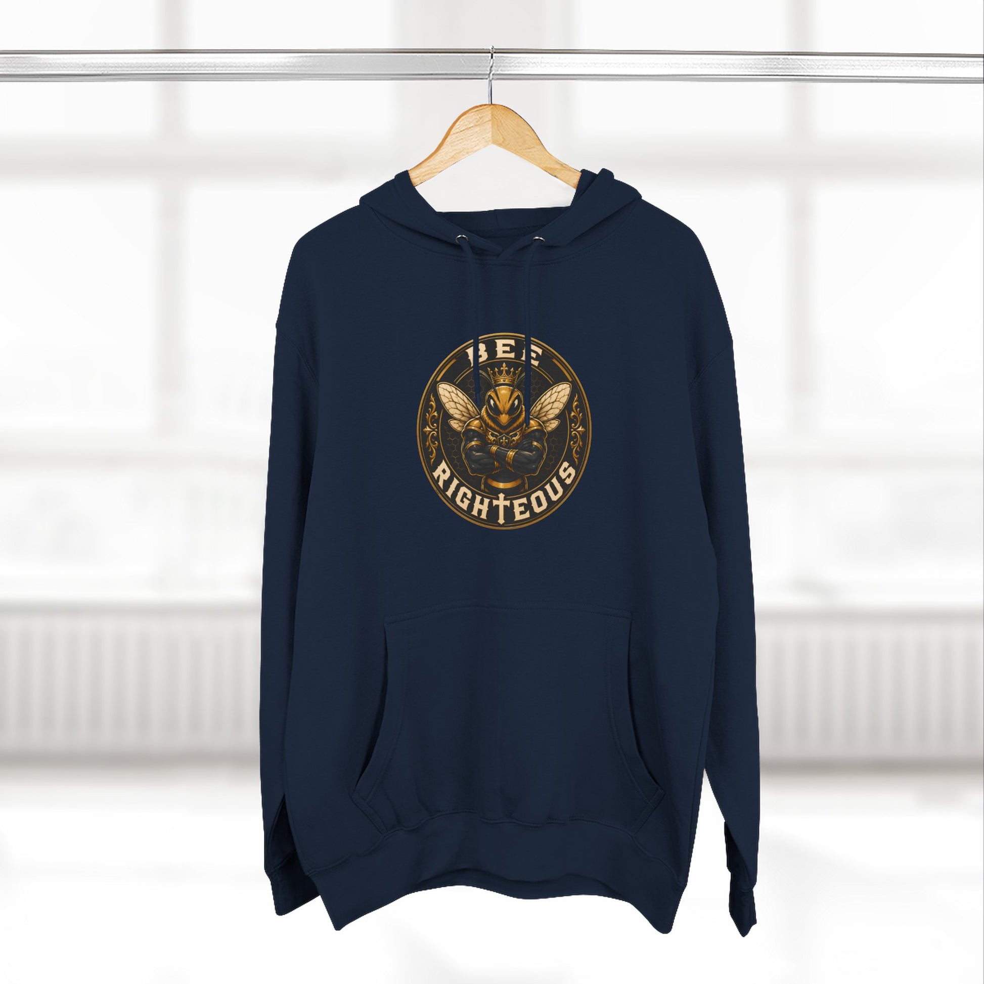 Green hoodie with a gold and white graphic design on a hanger against a white background