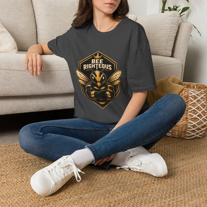 Person wearing a dark gray t-shirt with a bee graphic and 'Bee Righteous' text, sitting on a carpeted floor.
