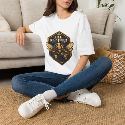 Person wearing a white t-shirt with a graphic design sitting on a couch.