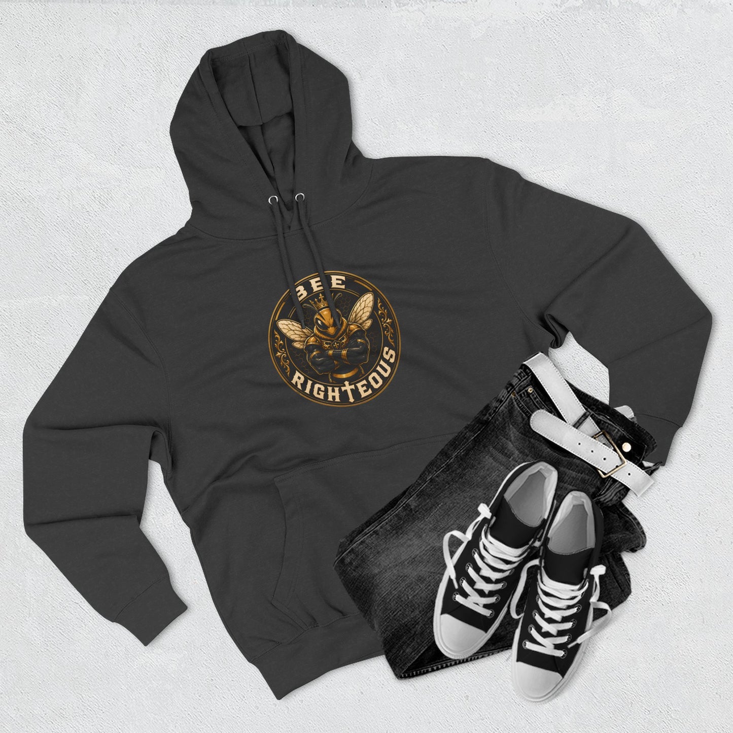 Black hoodie with a dog graphic, black jeans, and black sneakers on a light gray background