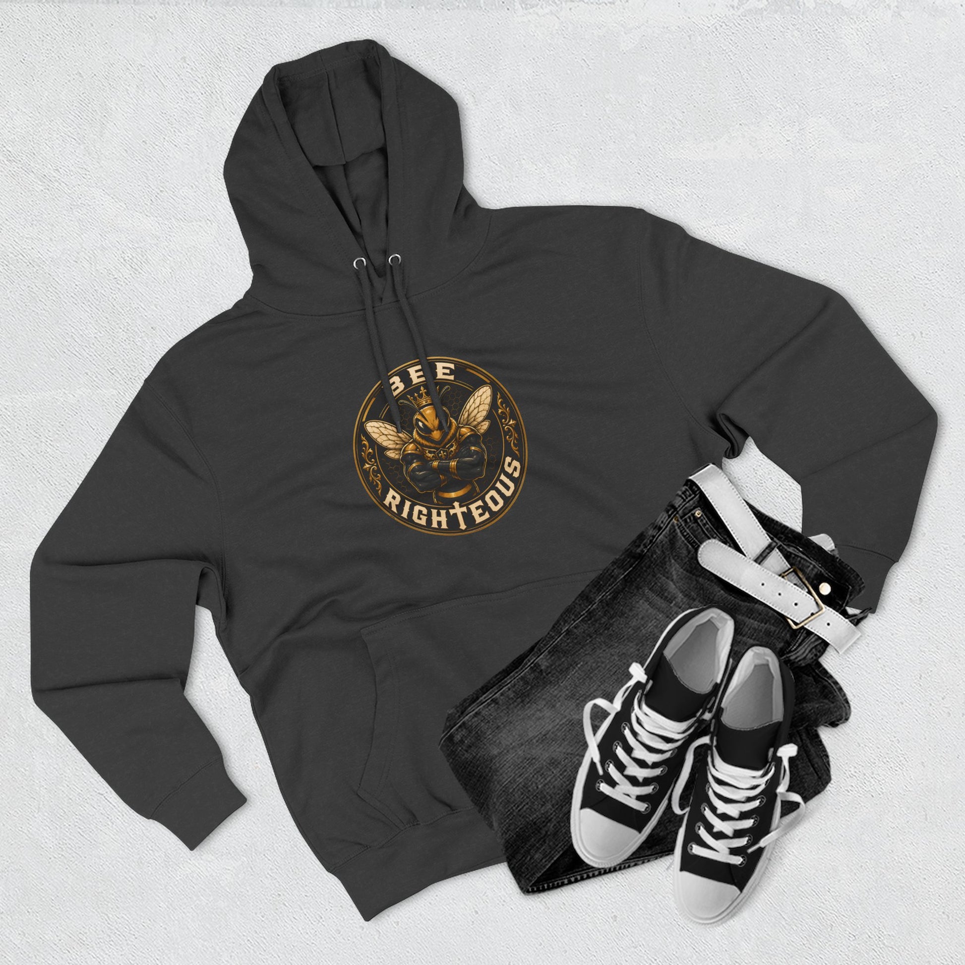 Black hoodie with a dog graphic, black jeans, and black sneakers on a light gray background