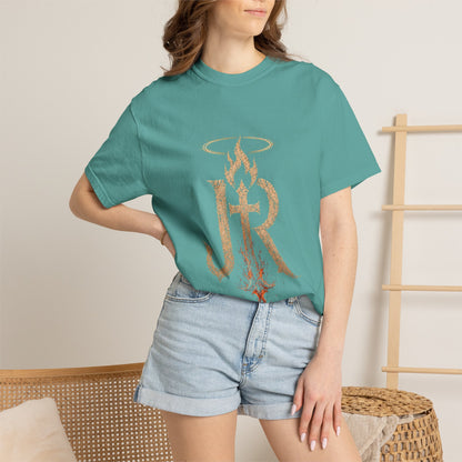 Person wearing a teal t-shirt with a logo and denim shorts in a casual setting.