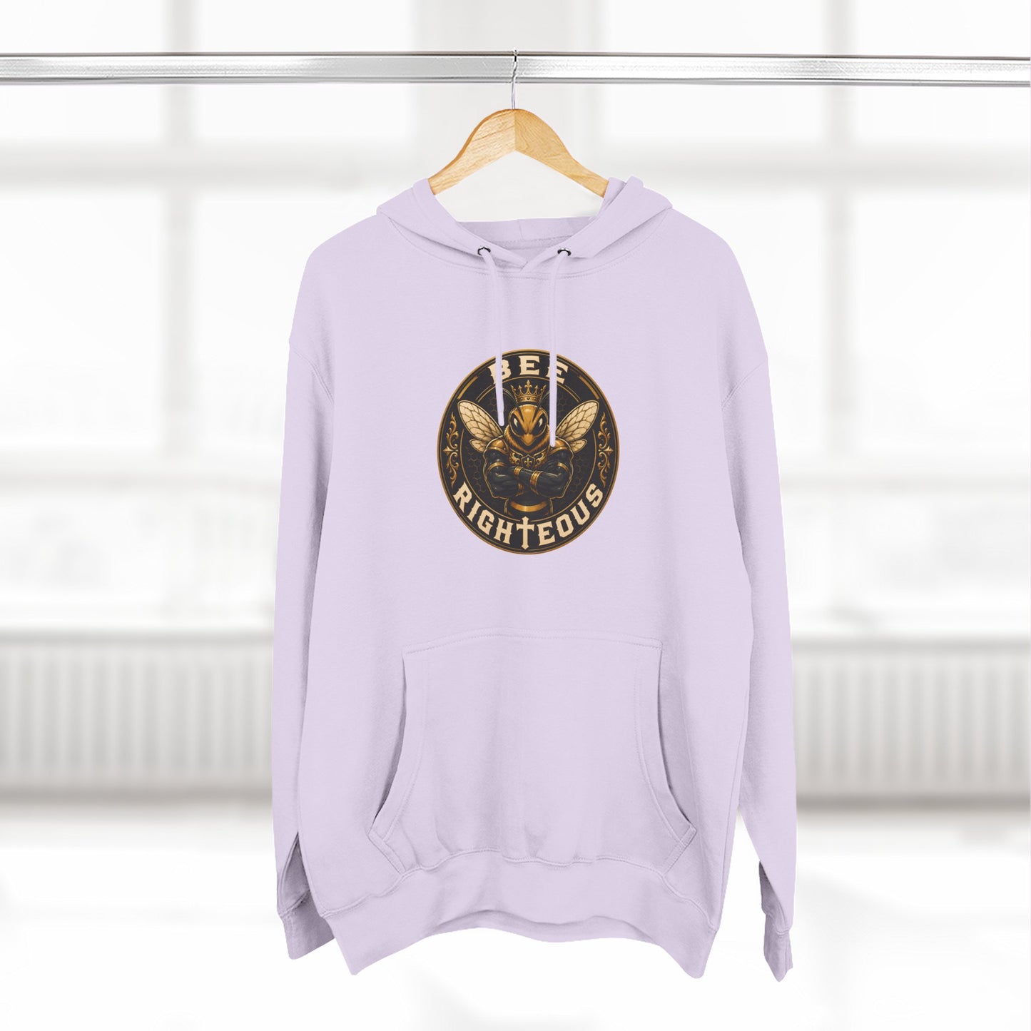 Lavender hoodie with a graphic design on a hanger against a white background