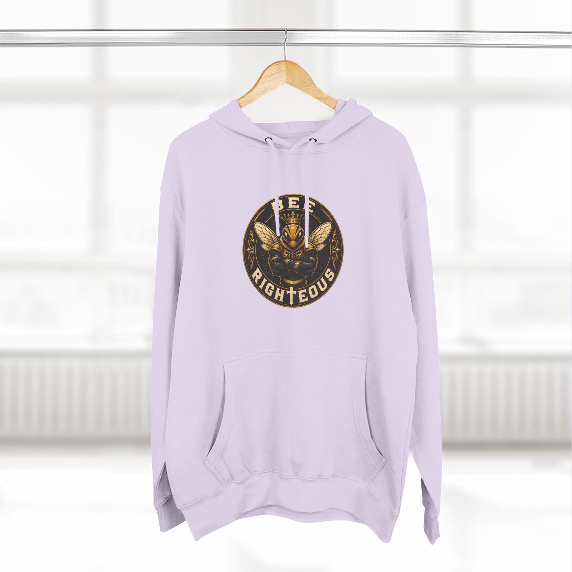 Lavender hoodie with a graphic design on a hanger against a white background