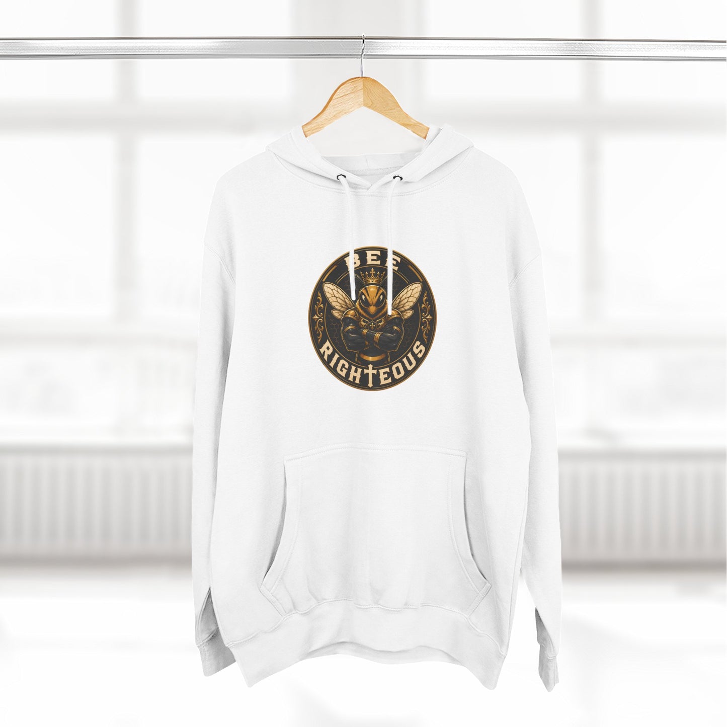 White hoodie with a gold and black logo on a wooden hanger against a white background