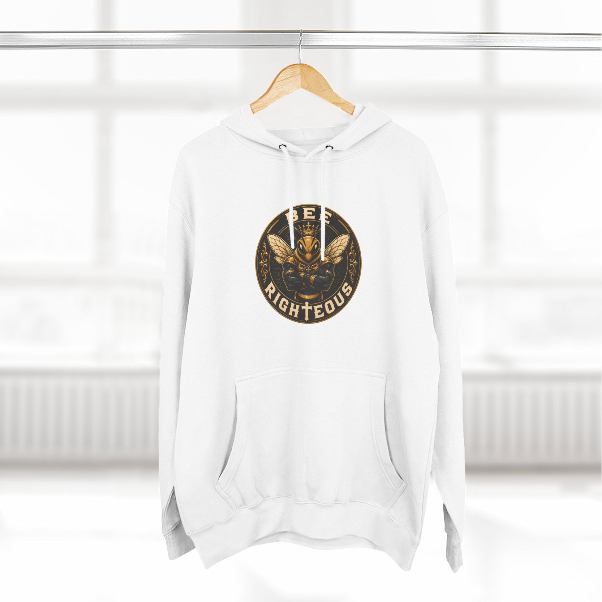 White hoodie with a gold and black logo on a wooden hanger against a white background